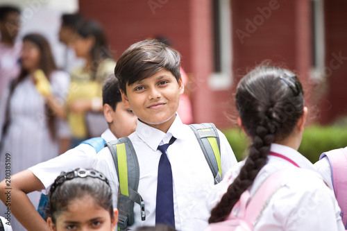 Group of schoolboys and schoolgirls at school campus