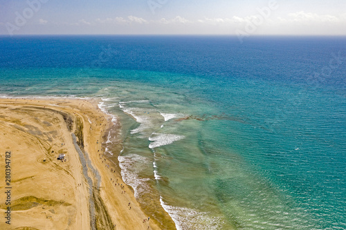 Aerial view of sandy seashore. Sunny beach at the seaside in summer.