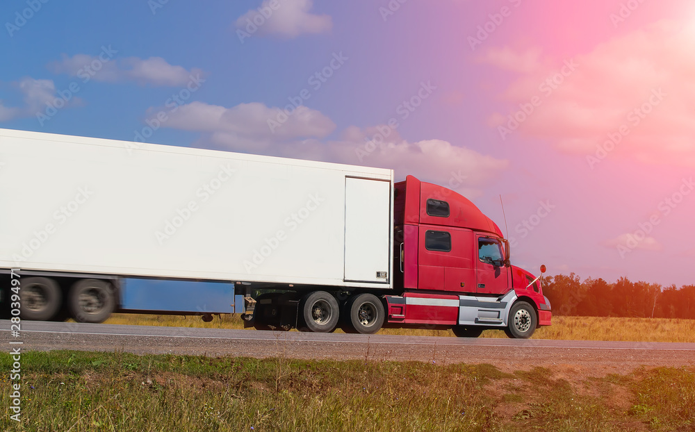 Large semi-trailer moves on a country road