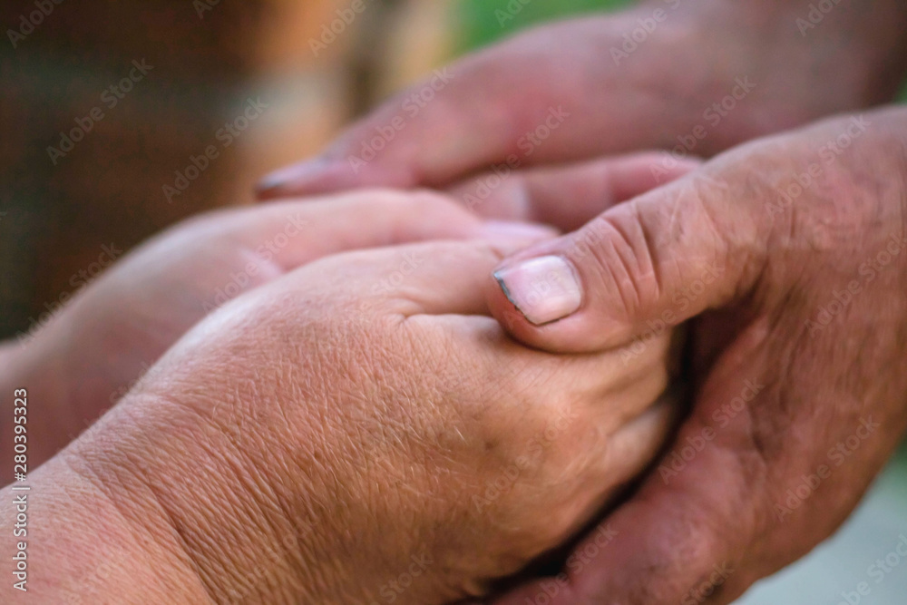 Two elderly people are holding hands. Hand in hand.
