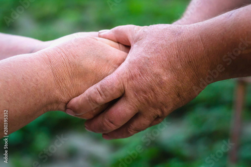 Two elderly people are holding hands. Hand in hand. © bogdana_severyn