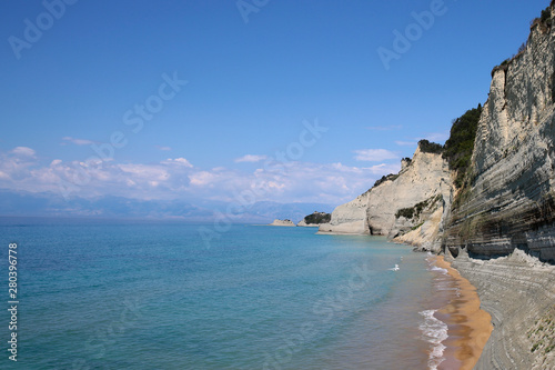 Aerial view of green rocky cliffs in the ocean.