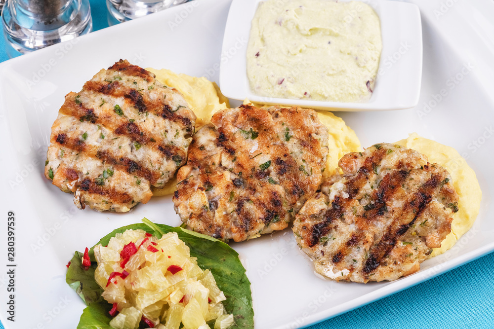  Fried fish patties served with vegetables, salad and greens and mashed potatoes according to Georgian recipe