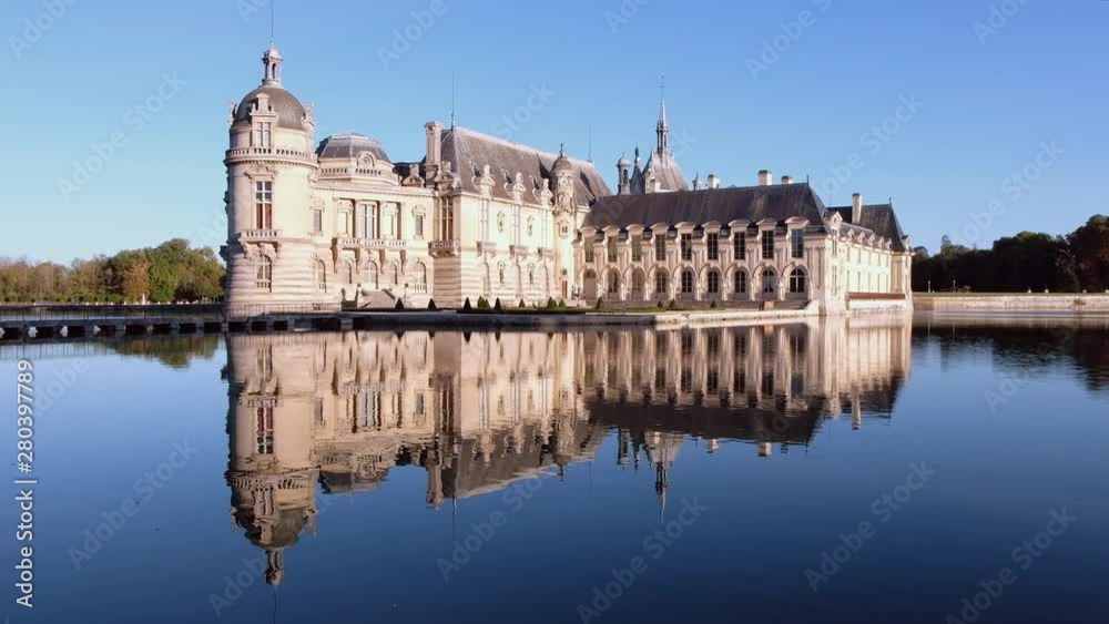 Castle of chantilly at sunset with reflection on pond, oise picardy france Castle of chantilly at sunset with reflection on pond, oise picardy france