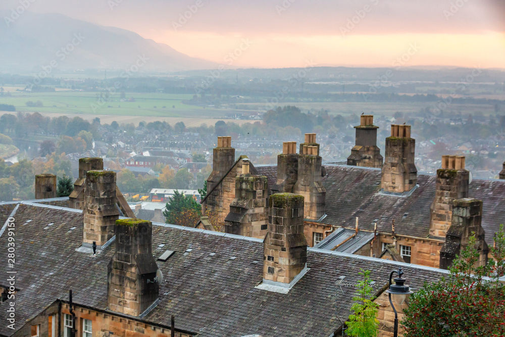 View over the roofs of houses in Scotland during sunset.