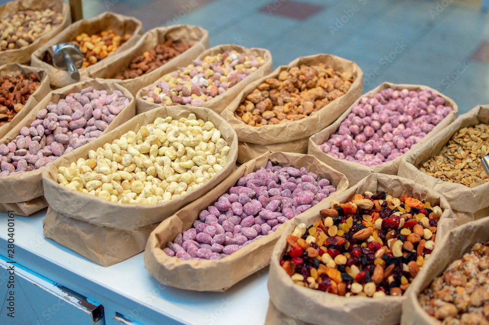 different types of sweet nuts in sacks in the street market. selective focus
