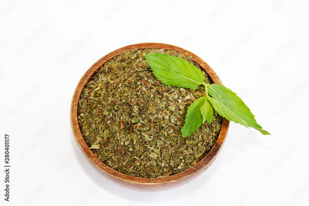 dried mint powder and natural green leaves of this plant in wooden plate dried mint powder and natural green leaves of this plant in wooden plate