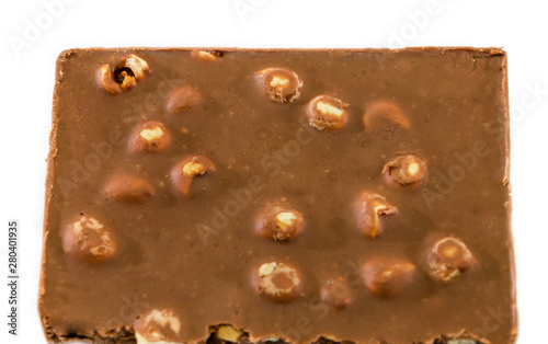 milk chocolate with nuts on a white background, closeup