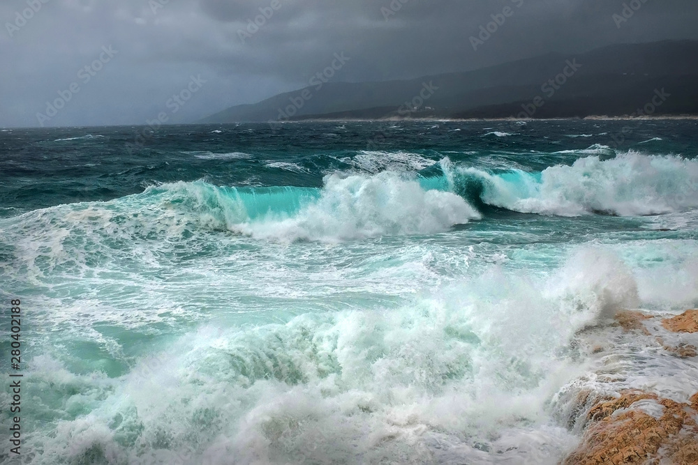 Stormy sea view near coastline at evening time. Waves, splashed Stormy sea view near coastline at evening time. Waves, splashed