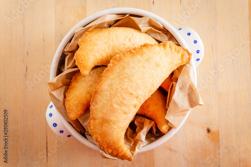 Three delicious fried panzerotto on a bowl. Typical food of Puglia, Italy