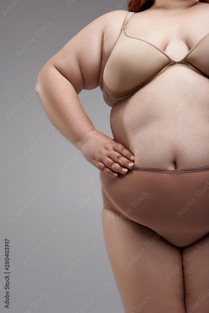 Fat lady wearing big size underwear and posing for camera