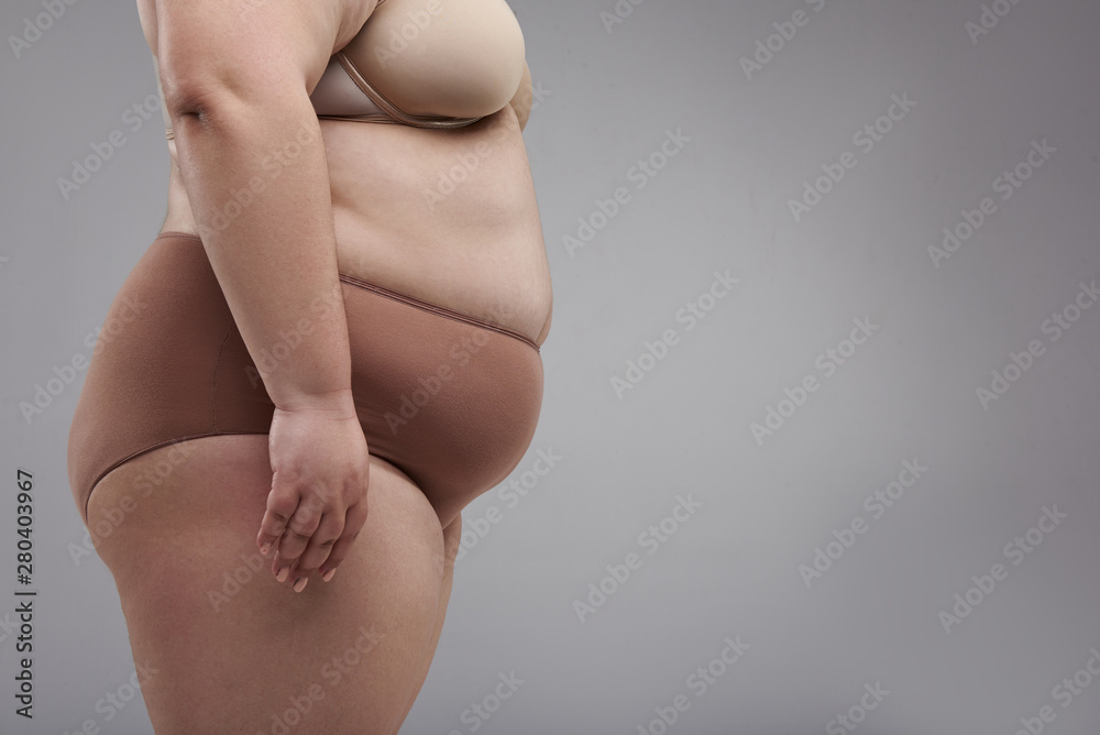 Fat female in big size underwear in studio
