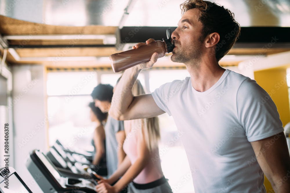 Beautiful fit people exercising together in gym Beautiful fit people exercising together in gym