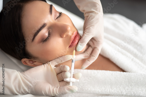 Young woman receiving beauty injections at spa salon