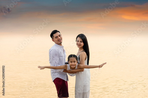 Happy family day: having fun at the beach.Father mothe and girl hold hands and run with fun along edge of sea © pic for you