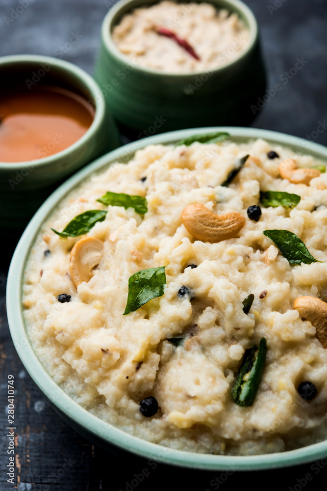 Ven pongal recipe is a popular South Indian food prepared with rice & moong dal and served with sambar and coconut chutney, selective focus Ven pongal recipe is a popular South Indian food prepared with rice & moong dal and served with sambar and coconut chutney, selective focus