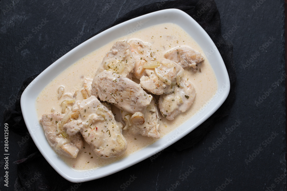 chicken with creamy sauce on dish on ceramic background chicken with creamy sauce on dish on ceramic background