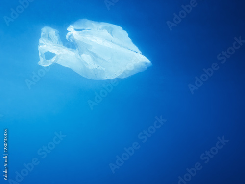 plastic bag floating under the ocean water