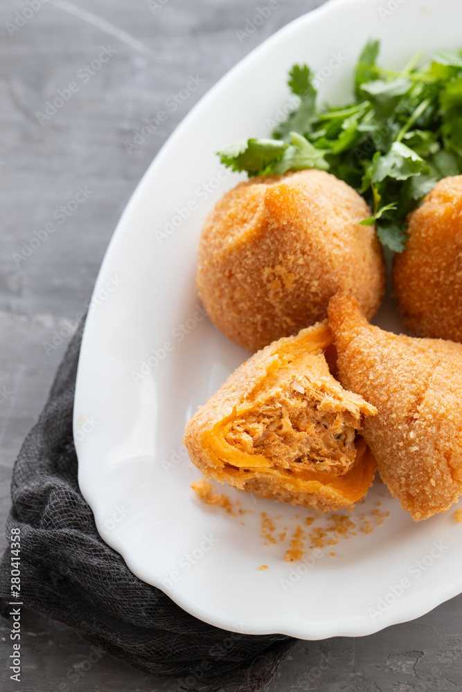 coxinha de frango, typical brazilian chicken croquette on white dish