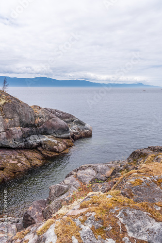 Bilde på lerret View over Inlet, ocean and island with rocks and mountains in beautiful British Columbia