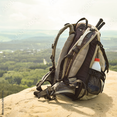Hipster hiker tourist backpack on background nature in mountain, blurred panoramic landscape, traveler relax holiday concept, view planning wayroad in trip vacation, travel adventure. © Nina