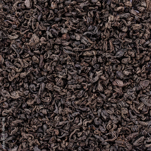 Black tea texture. Black tea loose dried tea leaves. Top view of black tea, marco. photo