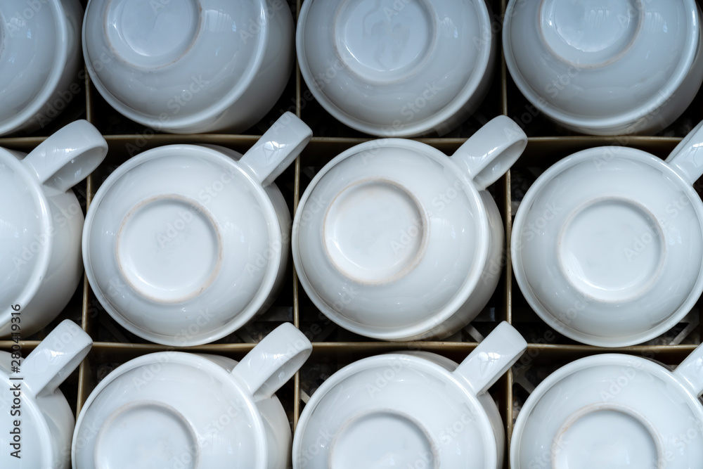 many of the same white mugs for drinks, coffee or tea. stand upside down in a drawer many of the same white mugs for drinks, coffee or tea. stand upside down in a drawer
