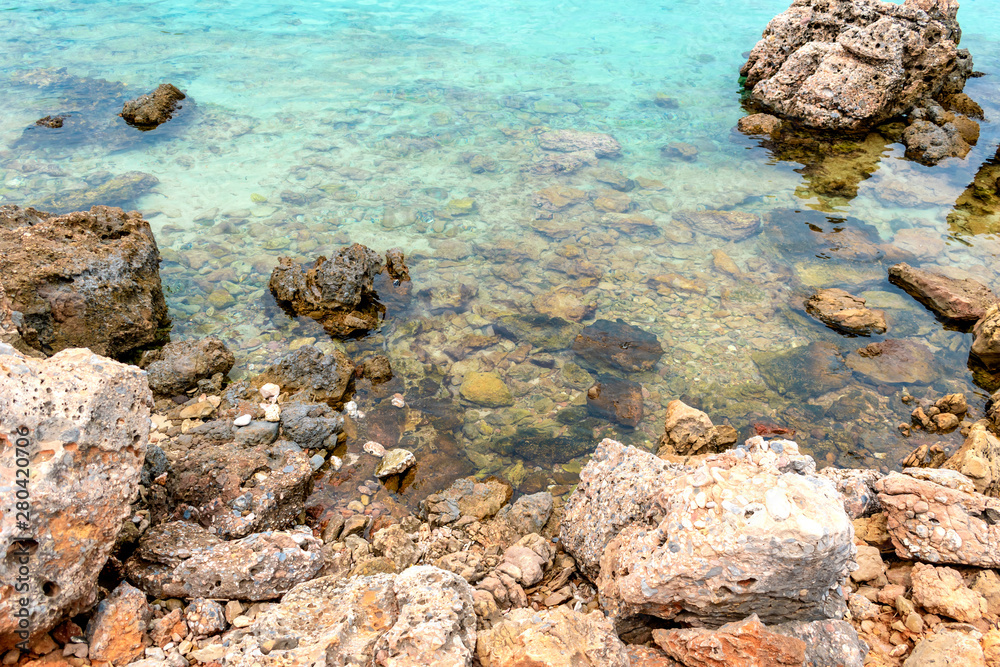 Stony seashore with blue water Stony seashore with blue water