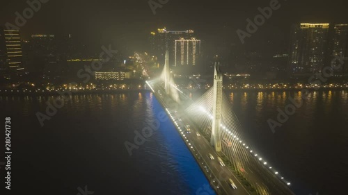 Bridge in Guangzhou City, Car Traffic at Night. Guangdong, China. Aerial Hyper Lapse, Time Lapse. Drone is Orbiting photo
