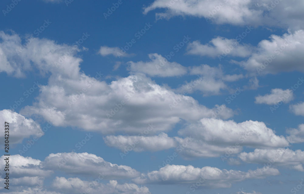 Blue sky background with white clouds. Cropped shot, horizontal, free space. Concept of natural beauty. Blue sky background with white clouds. Cropped shot, horizontal, free space. Concept of natural beauty.