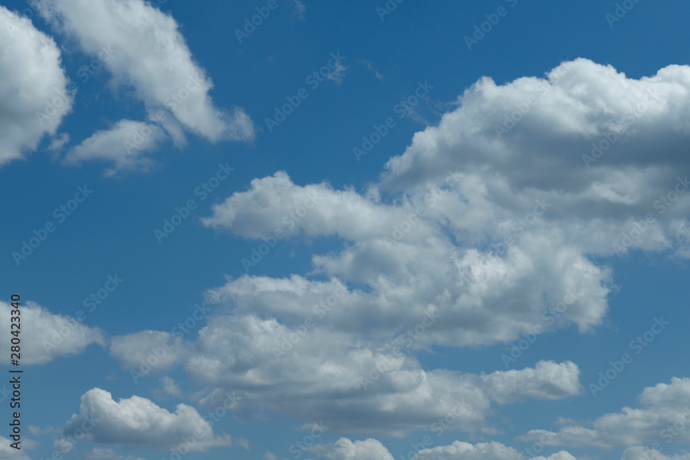 Blue sky background with white clouds. Cropped shot, horizontal, free space. Concept of natural beauty. Blue sky background with white clouds. Cropped shot, horizontal, free space. Concept of natural beauty.