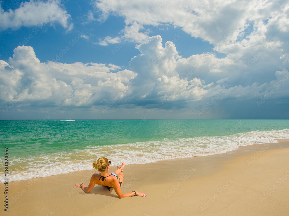 Woman enjoying her holidays on the tropical beach i Woman enjoying her holidays on the tropical beach i