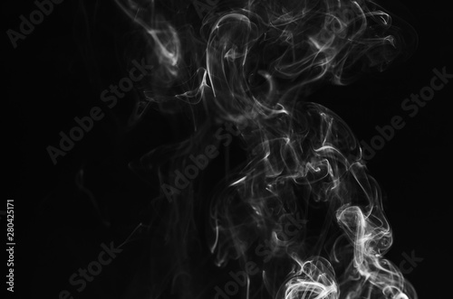 abstract fragment movement of white smoke on black background. © thithawat