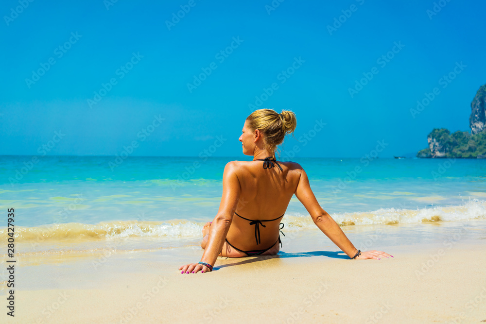 Cute woman relaxing on the summer beach. Cute woman relaxing on the summer beach.