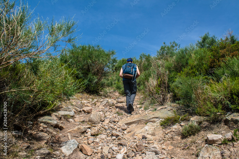 man walks to the peak of the mountain