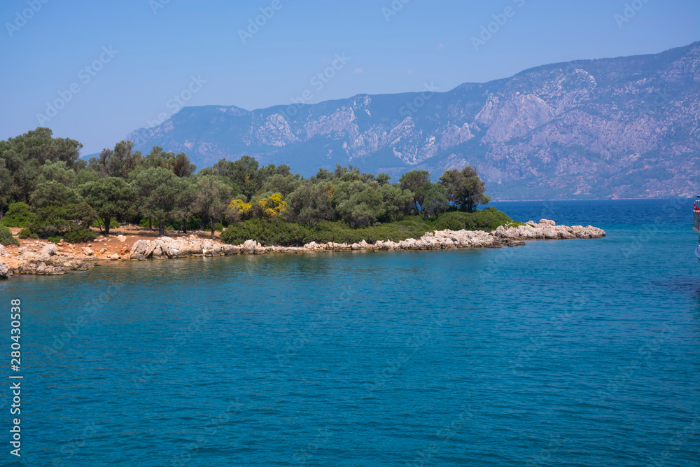 Aegean Islands on mountains and blue sky background, Turkey. Tropical wallpaper, paradise beach