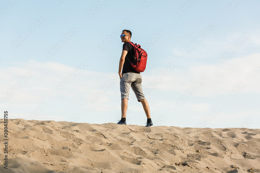 Backpacker tourist standing desert trail looking beautiful mountains landscape view, hiking traveling