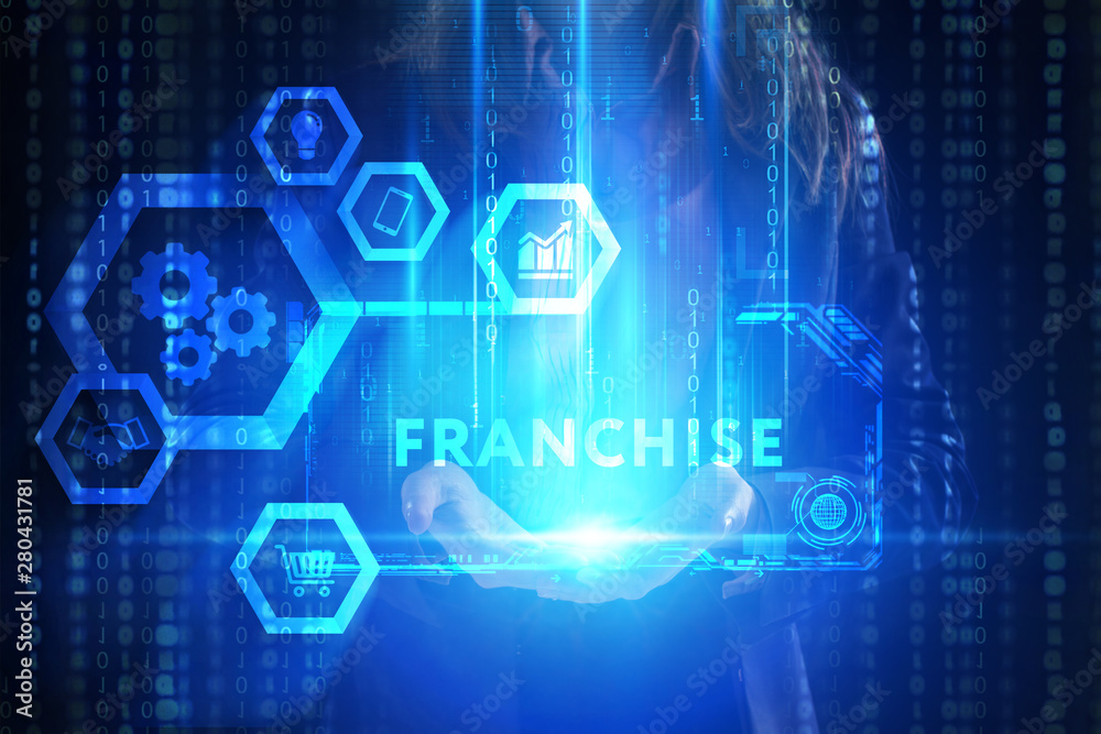 Fototapeta premium The concept of business, technology, the Internet and the network. A young entrepreneur working on a virtual screen of the future and sees the inscription: Franchise