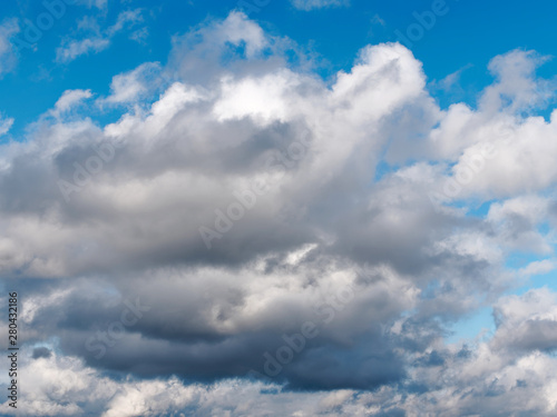 Natural looking afternoon sky with beautiful summer rain cumulus and stratus clouds with copypaste for design background