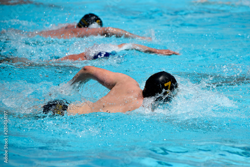 Athletes swimming freestyle on a swimming pool © Michalis Palis
