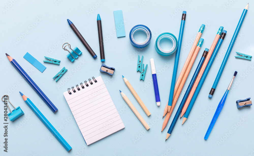 Flat lay of office, school stationery on blue background Flat lay of office, school stationery on blue background