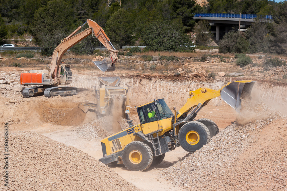 Excavator machines in the construction site Excavator machines in the construction site