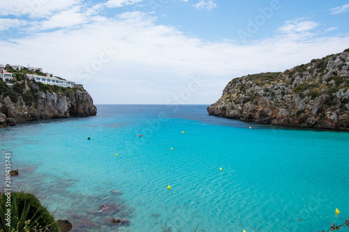 Turquoise water and beautiful sandy beach at Cala en Porter, Menorca.