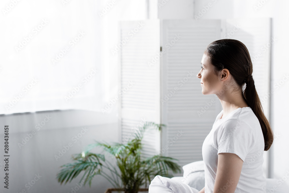 attractive young woman with ponytail looking away in clinic attractive young woman with ponytail looking away in clinic