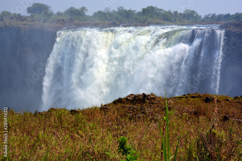 Victoria Falls, or Mosi-oa-Tunya (Tokaleya Tonga: The Smoke That Thunders), is a waterfall in southern Africa on the Zambezi River at the border between Zambia and Zimbabwe photo