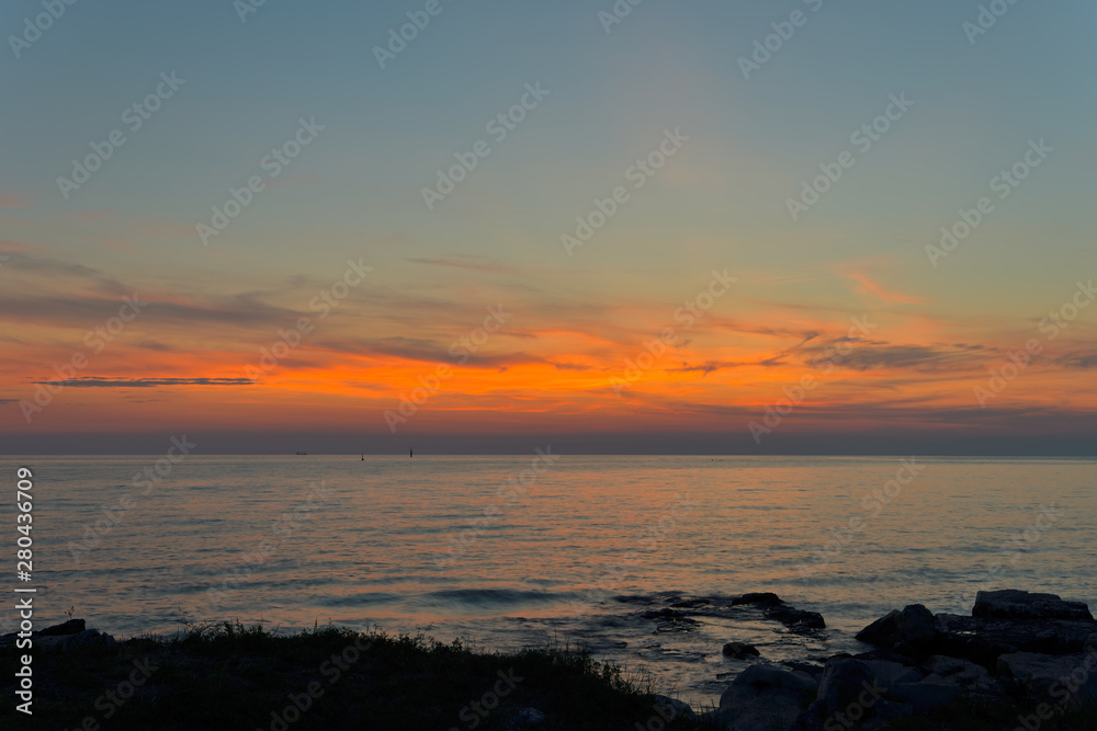 Red sunset with blue sky from the sea shore