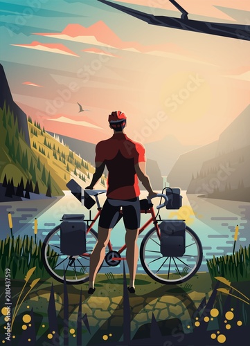 Cyclist in the mountains staring at the lake