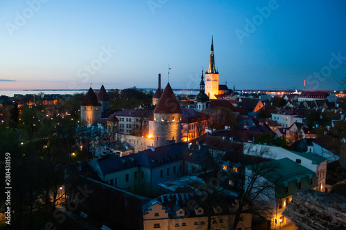 Beautiful scenic aerial view of the Tallinn old town, Estonia with towers and churches, Baltic sea on the background, summer night