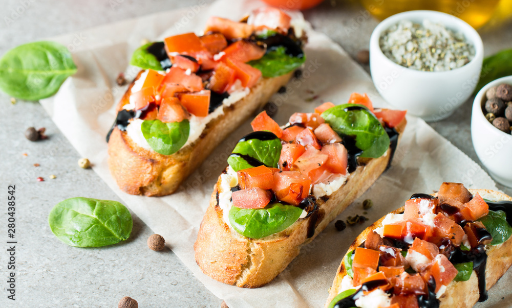 Tomato and cheese fresh made bruschetta. Italian tapas, antipasti with vegetables, herbs and oil on grilled ciabatta and baguette bread. Sandwich. Tomato and cheese fresh made bruschetta. Italian tapas, antipasti with vegetables, herbs and oil on grilled ciabatta and baguette bread. Sandwich.