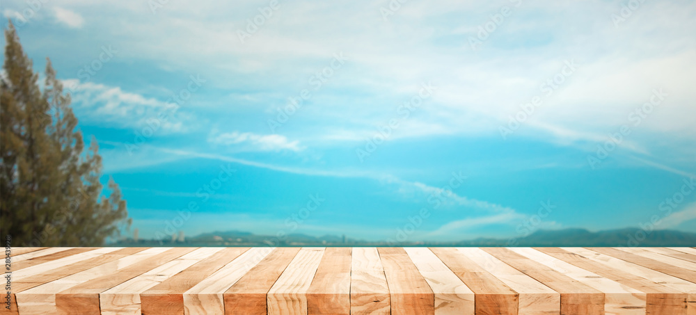 Empty of wood table top with blur of tree and mountain view background.For montage product display or design keyvisual